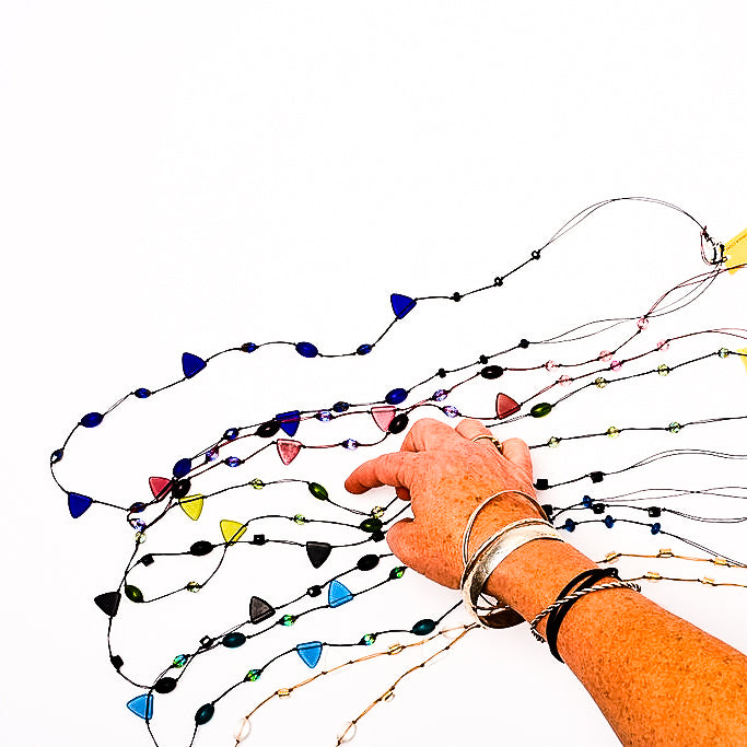 Frosted Czech glass long triangle necklaces with hand for scale