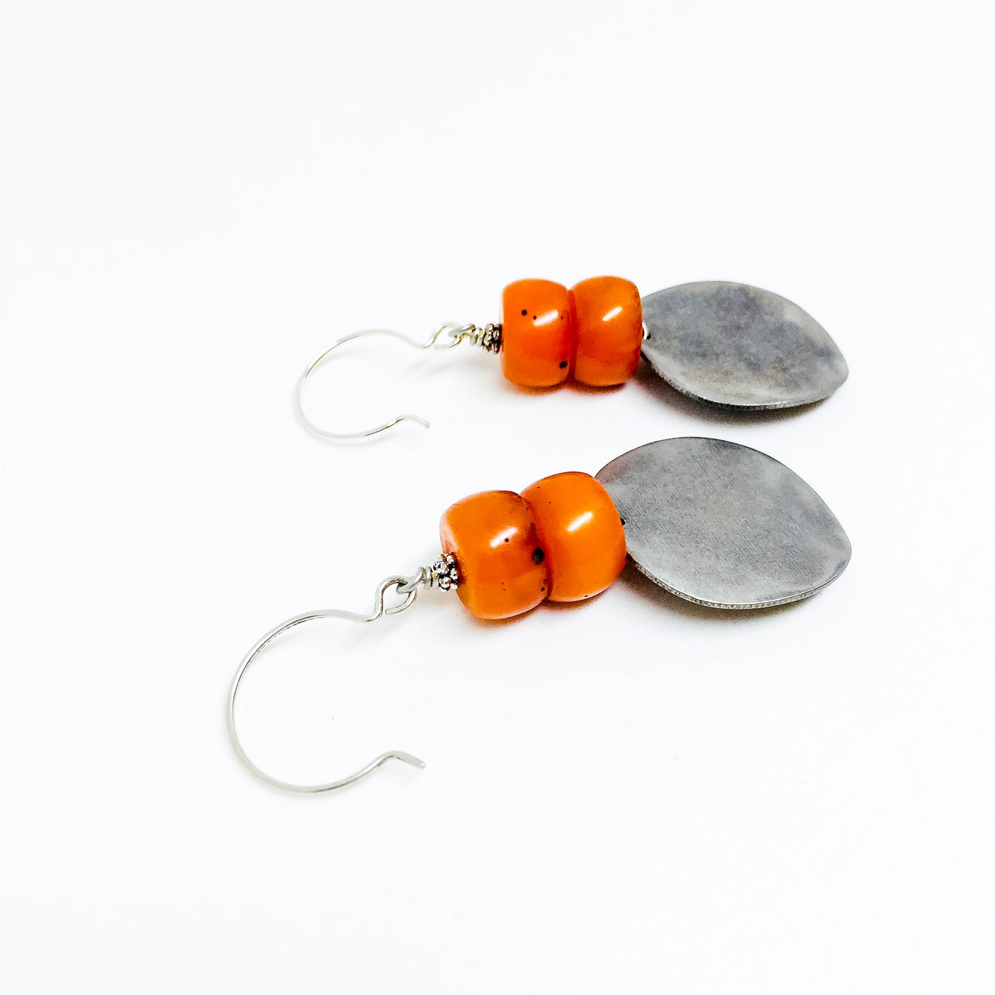 Matte silver-tone discs and deep orange resin bead earrings alt view
