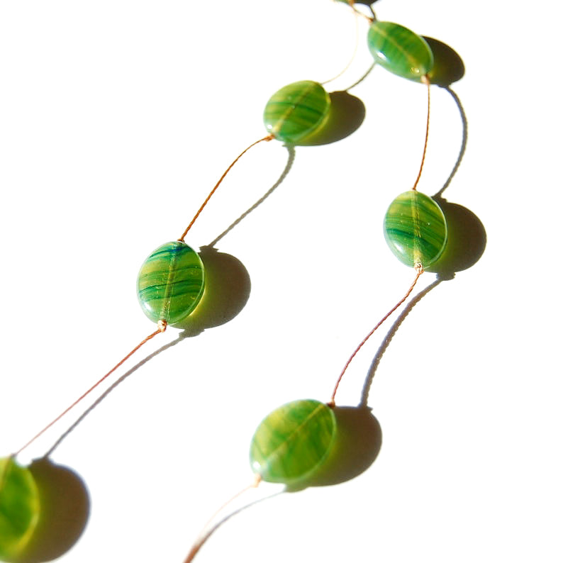 Flat green oval Czech glass bead necklace detail